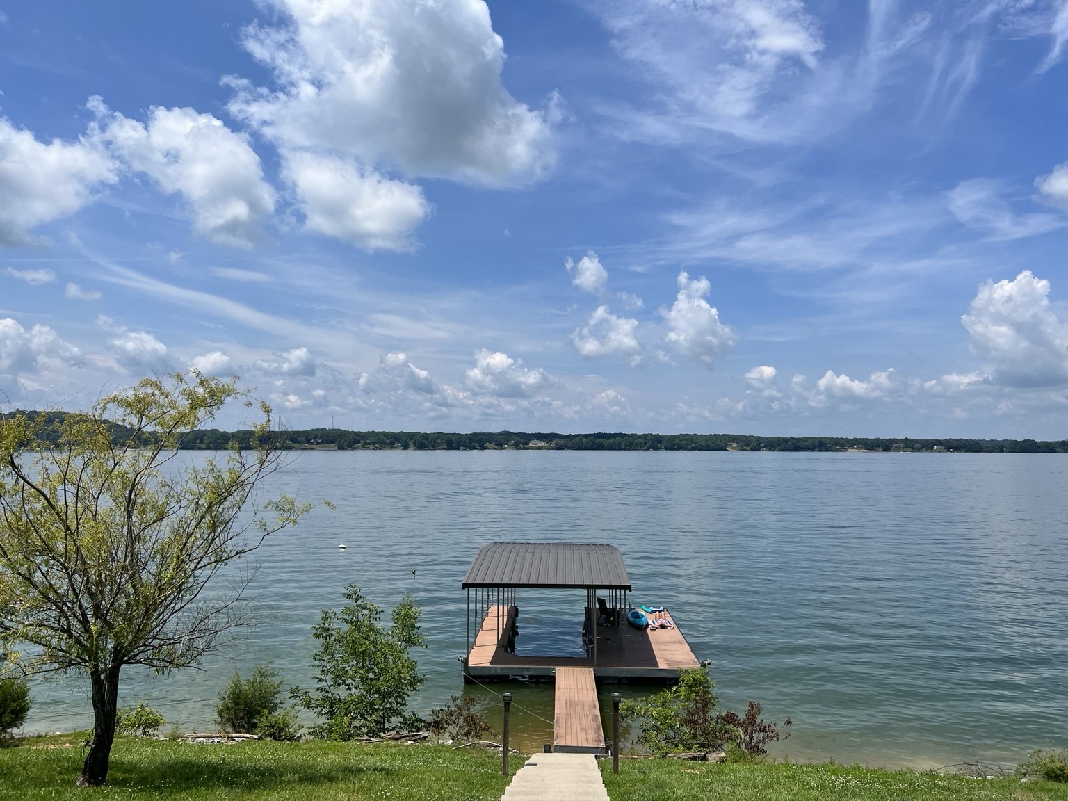 Private boat dock on Douglas Lake under a bright summer sky