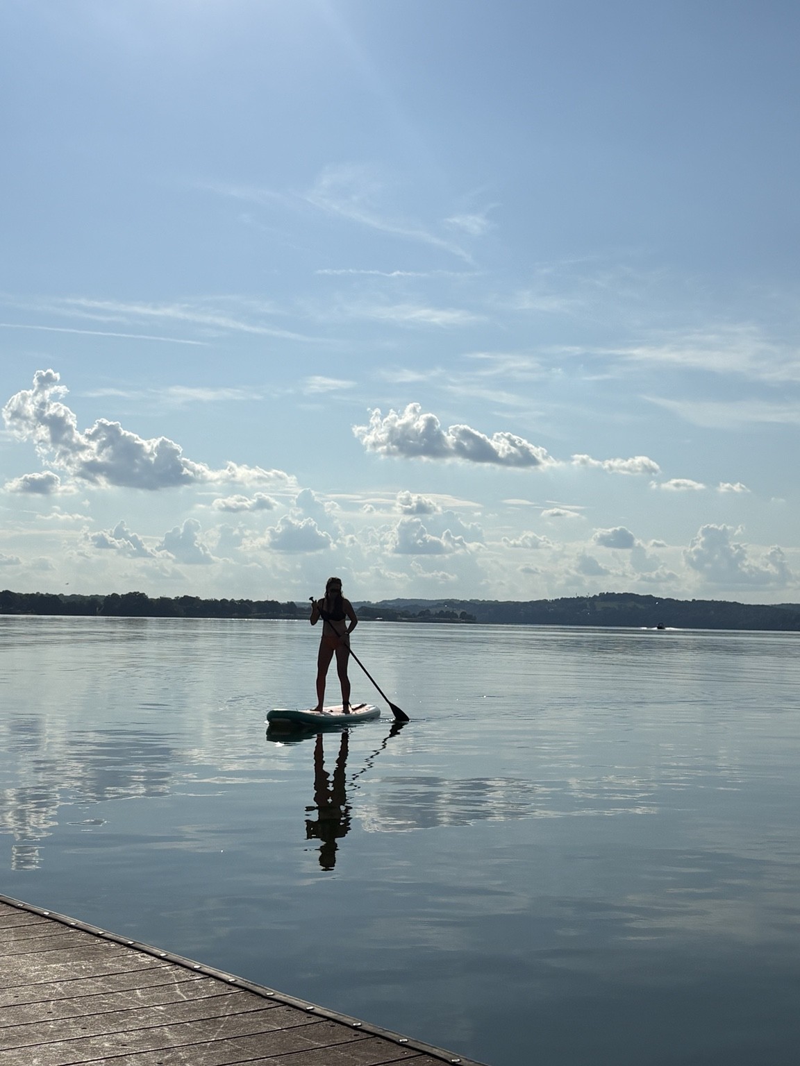 Paddleboarder on calm Douglas Lake water